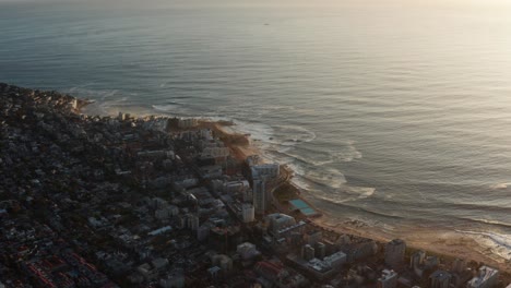 aerial shot of cape town promenade lined with sea view apartments. ocean facing suburb in south africa.