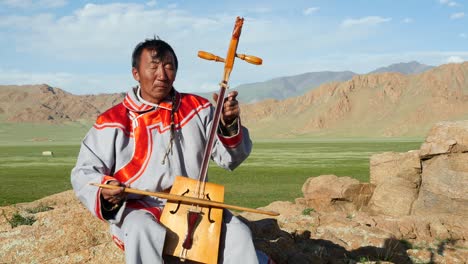 traditional mongolian throat singer practicing in the outdoors near the altai mountains of west mongolia