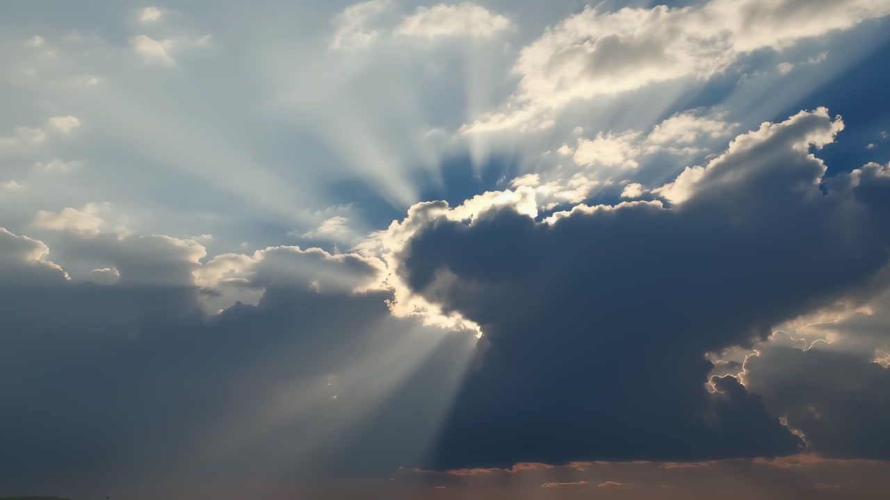 Hyper-realistic shot of a dramatic cloudy sky with majestic sun rays piercing through clouds. Inspiring, cinematic atmosphere