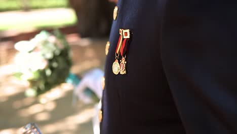 slow motion shot of a decorated soldier wearing his medals on his outfit