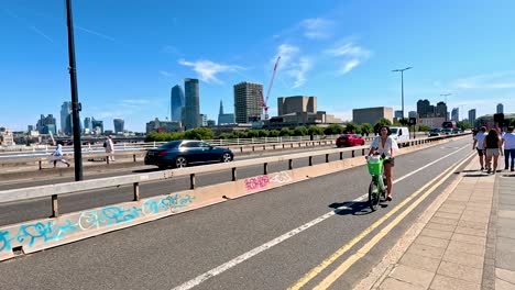 cyclist rides along a busy london street