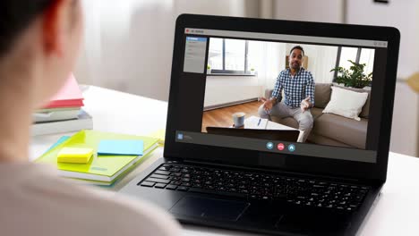 people,-technology-and-online-communication-concept--laptop-with-family-having-video-call-or-virtual-birthday-party-on-screen,-cake,-gift-box-and-coffee-on-table-at-home