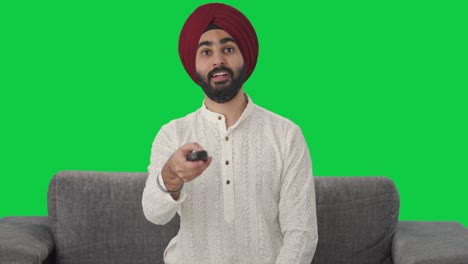 sikh indian man watching tv green screen