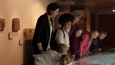 pupils on school trip to museum looking at map shot on r3d