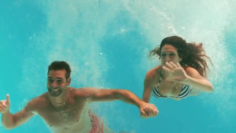 happy couple swimming underwater