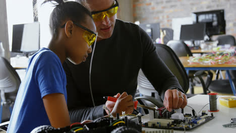 father teaching her daughter about soldering iron 4k