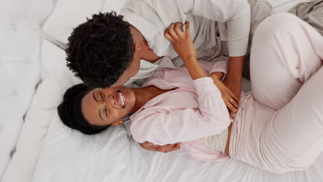 Love,-black-couple-and-bedroom-fun-while-laughing