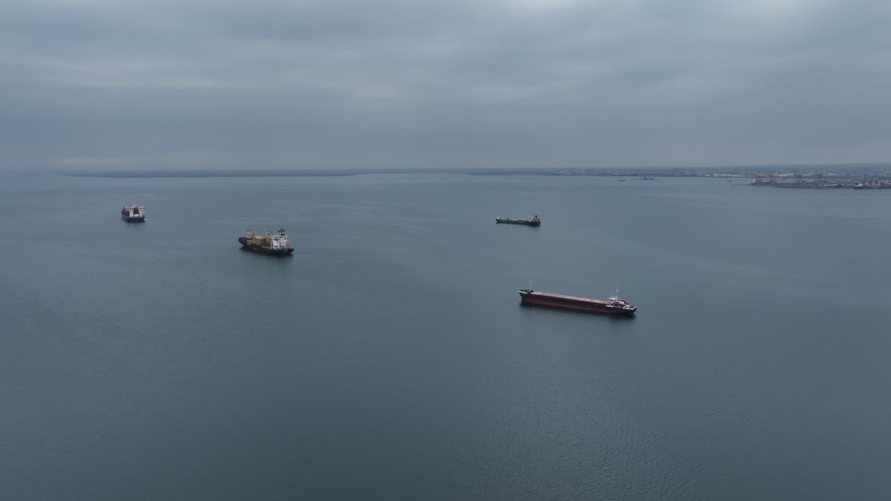 Ships in the Thermaic Gulf of Thessaloniki, calm water with container ships in the distance