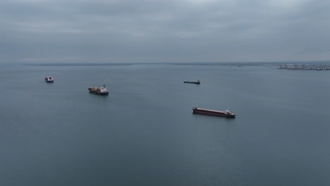 ships in the thermaic gulf of thessaloniki, calm water with container ships in the distance