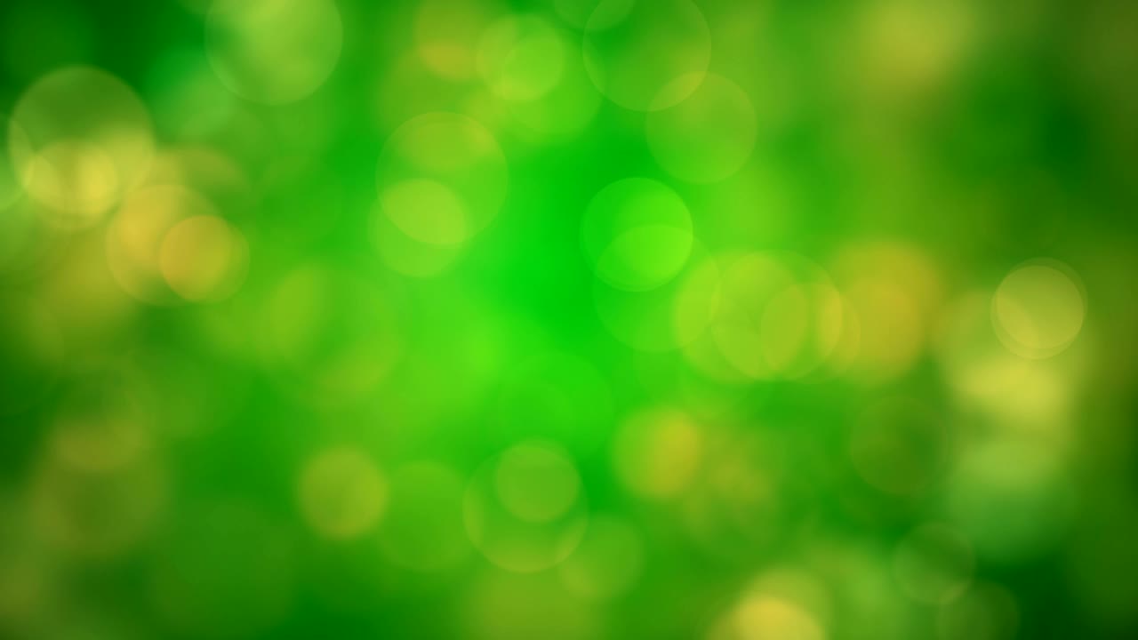 Bevægelige grønne, gule glitrende lys, defokuserede lysrefleksioner, loopbar bokeh baggrund