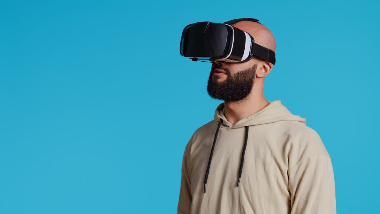Middle eastern adult using virtual reality glasses in studio