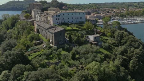 aerial over the old town of capodimonte on lake bolsena, province of viterbo, italy