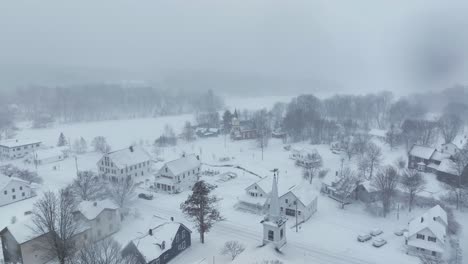 flight over snow-covered monson town towards frozen lake