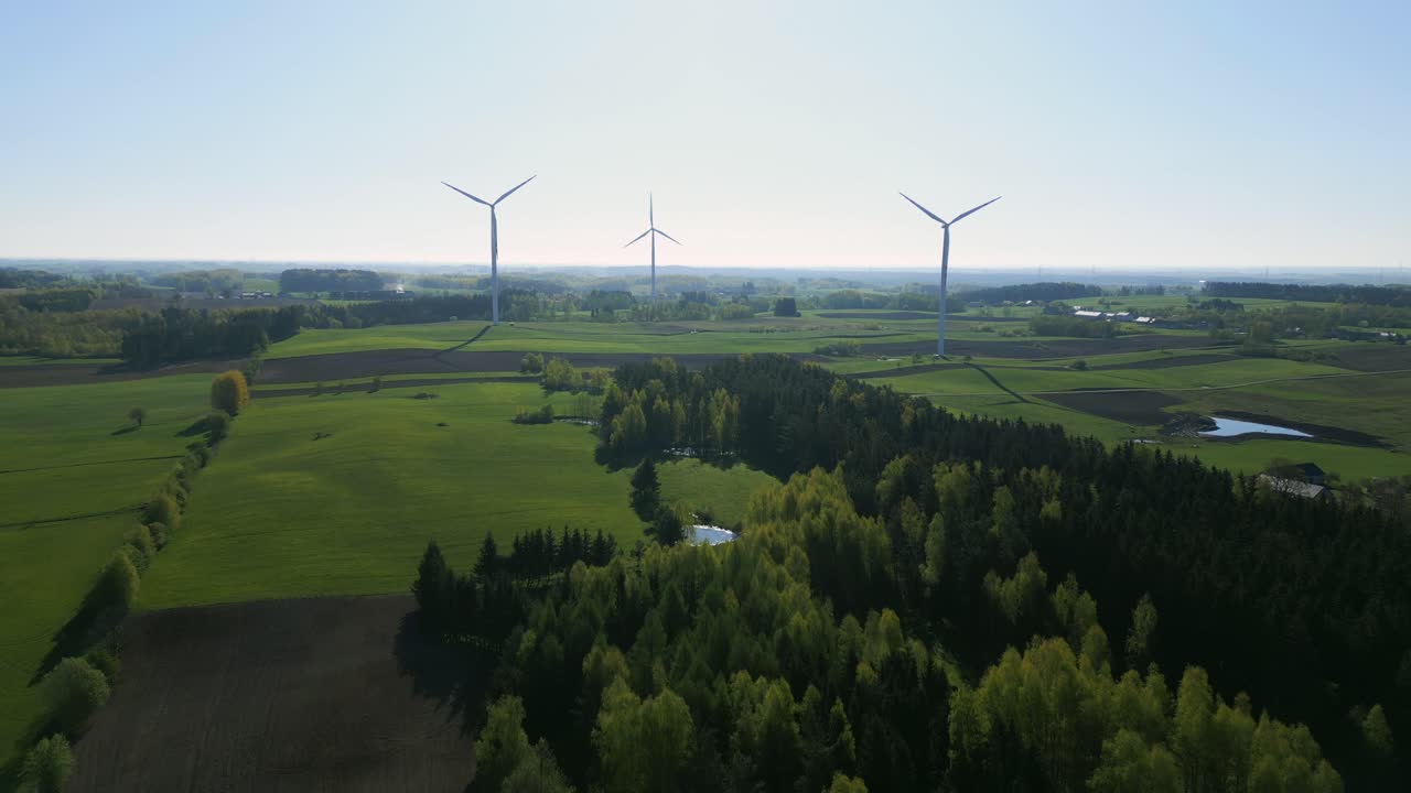 A majestic landscaped farmland adorned with wind turbines in the distance