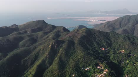 hong kong lantau island,silvermine bay in mui wo. lantau island view shek pik reservoir and car countryside of hong kong city aerial shot.aerial top view of village surrounding landscape
