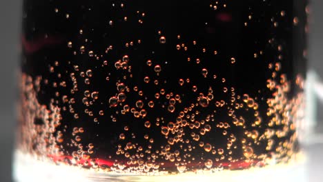 cococola bubbles in glass with closeup view