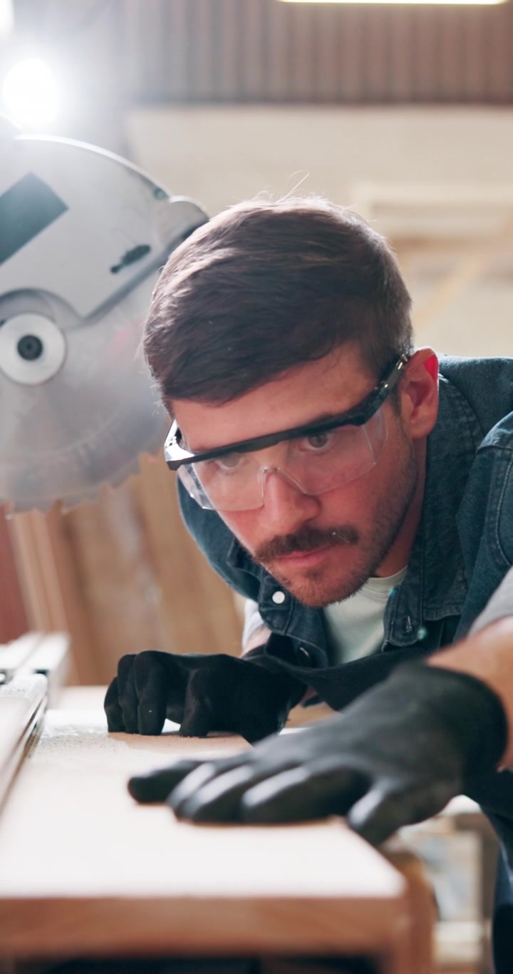 Focused Carpenter Measuring Wood Plank in Workshop