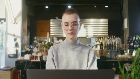 woman working on laptop in cafe