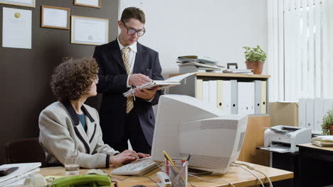 woman using a retro computer in vintage office.