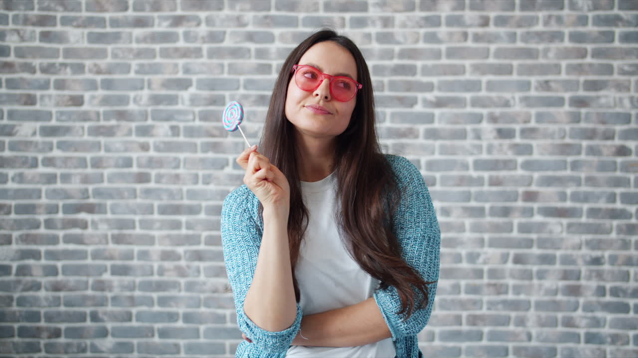Woman with lollipop and red glasses