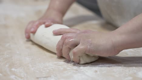 hands kneading dough for baking bread