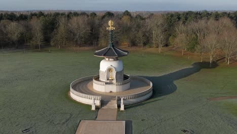 An-aerial-view-of-the-Peace-Pagoda-at-Willen-Lake-in-Milton-Keynes,-on-a-cold-winter-morning-with-the-sun-shining