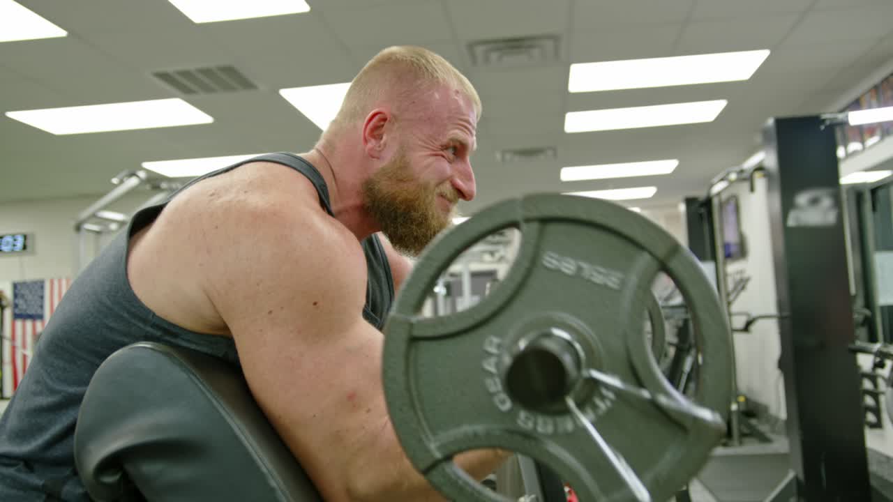 Strong bodybuilder lifting weights. Athletic person effort