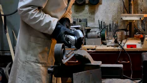 worker cutting metal with grinder. sparks while grinding iron