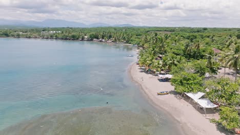 aerial flyover transparent caribbean sea with coral reefs and rocks at playa palenque,san cristobal