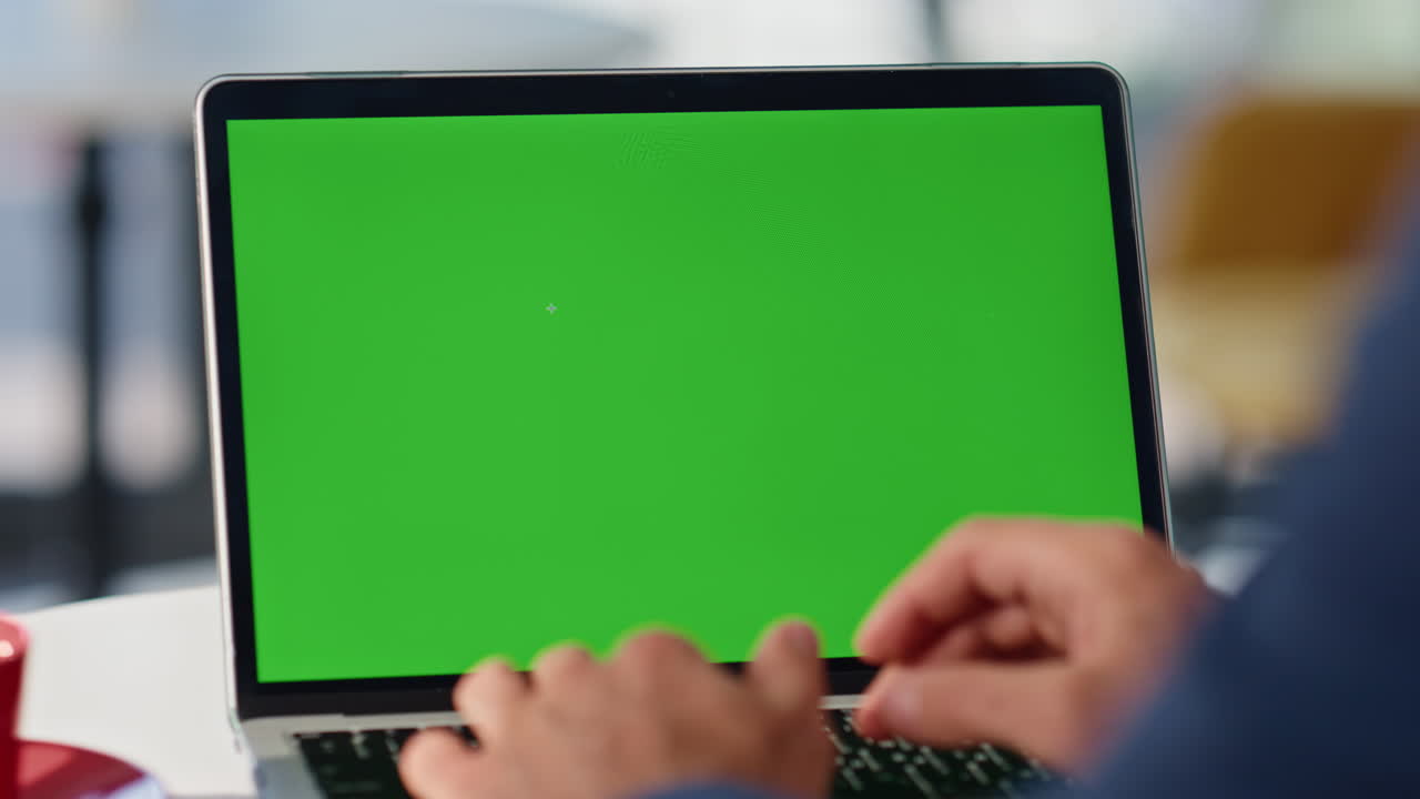 Unknown man typing greenscreen laptop keyboard working at cozy cafe closeup