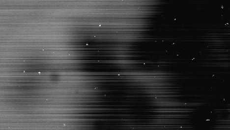 animation of multiple white specks and lines moving on seamless loop in black and white