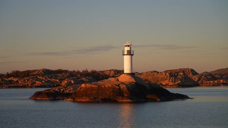 lighthouse stromstad fjord ursholmen sweden ferry boat ride land of the svea sverige calm sea ocean water late arctic afternoon sunset strömstad nordkoster enchanting coastal beauty circle motion