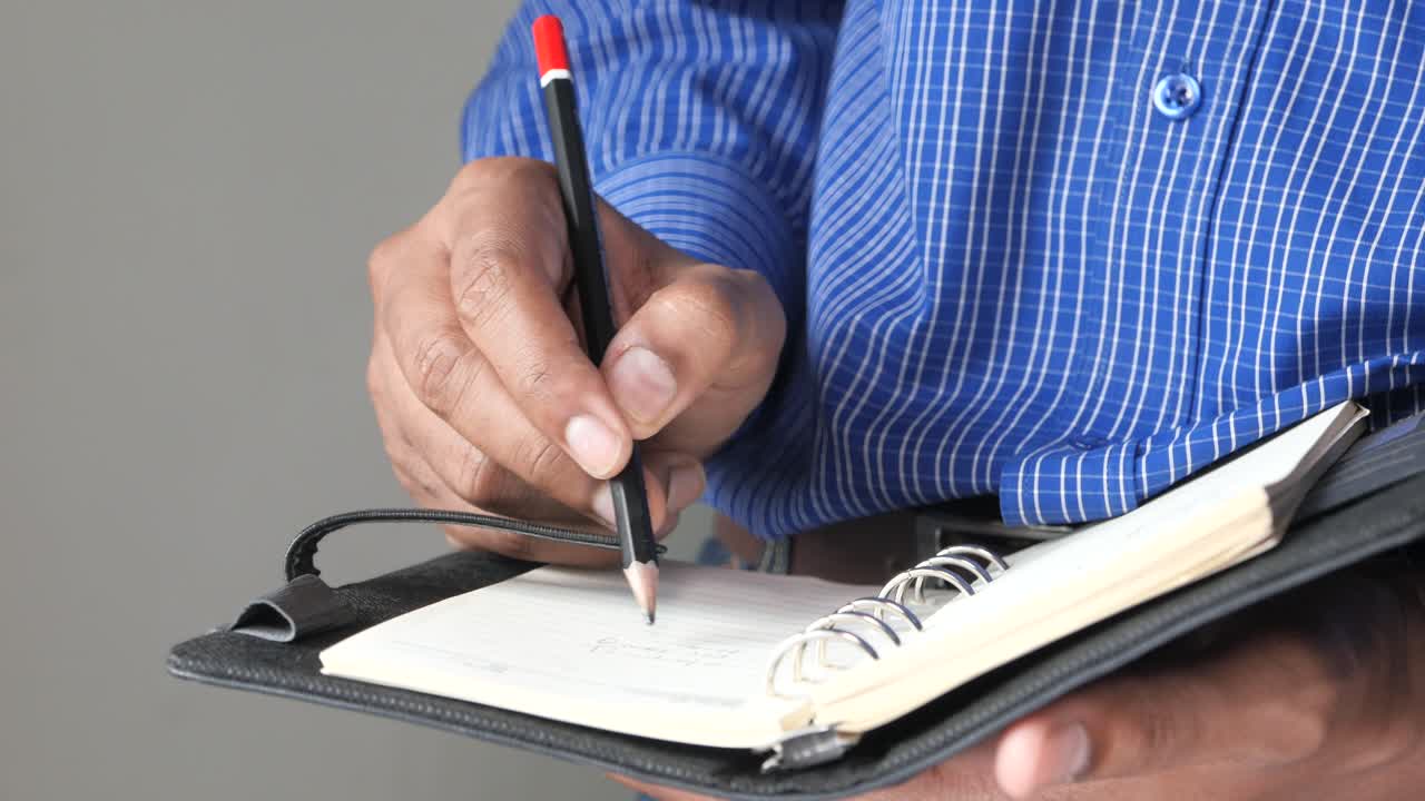 persona que escribe en un cuaderno