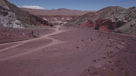 aerial shot of mountain rocks and vast fields in rainbow valley, chile