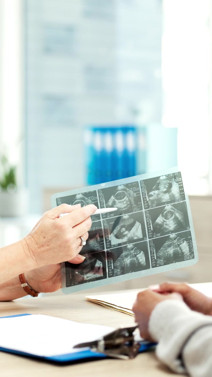 Doctor Explaining Ultrasound Results to Patient in Clinic