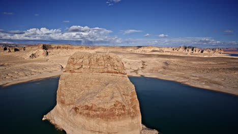 aerial perspective highlighting a colossal rock formation in lake powell, encircled by breathtaking desert canyons near page, arizona.