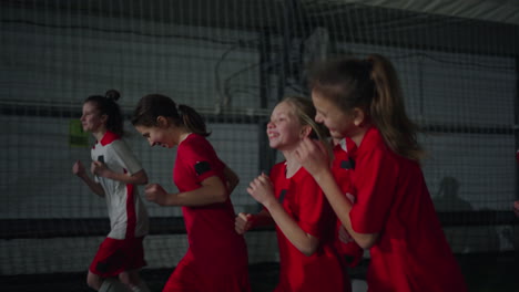 young girls soccer team training indoors