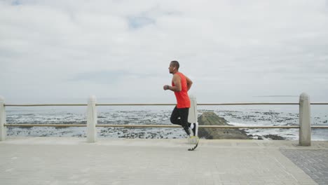 side view man with prosthetic leg running