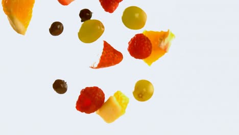 Fruit-salad-falling-against-white-background-4k