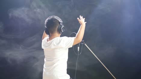 young boy singing in recording studio