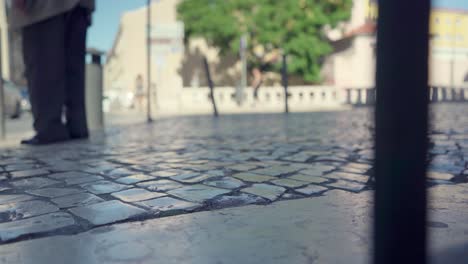 ancient man walking on white pavement with walking stick