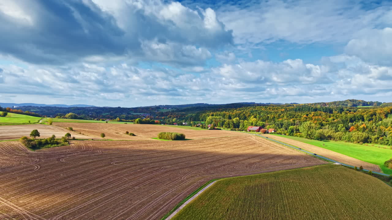 Plowed fields on a sunny autumn day top view. Rural fields with cultivated land. Autumn field top view