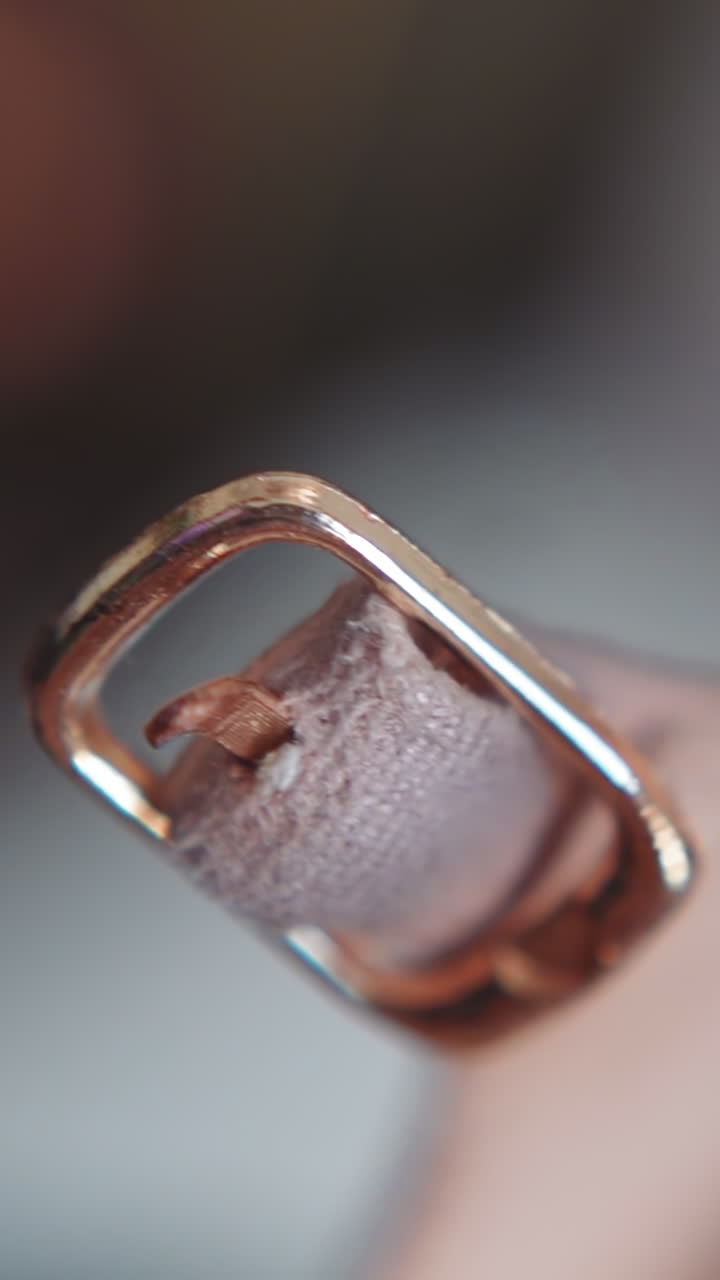 Small golden buckle of stylish leather women shoe on blurred background macro view. Footwear and accessory for festive event. Clothes item detail