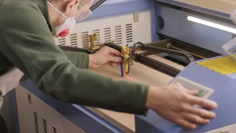 worker sets up a cnc laser machine