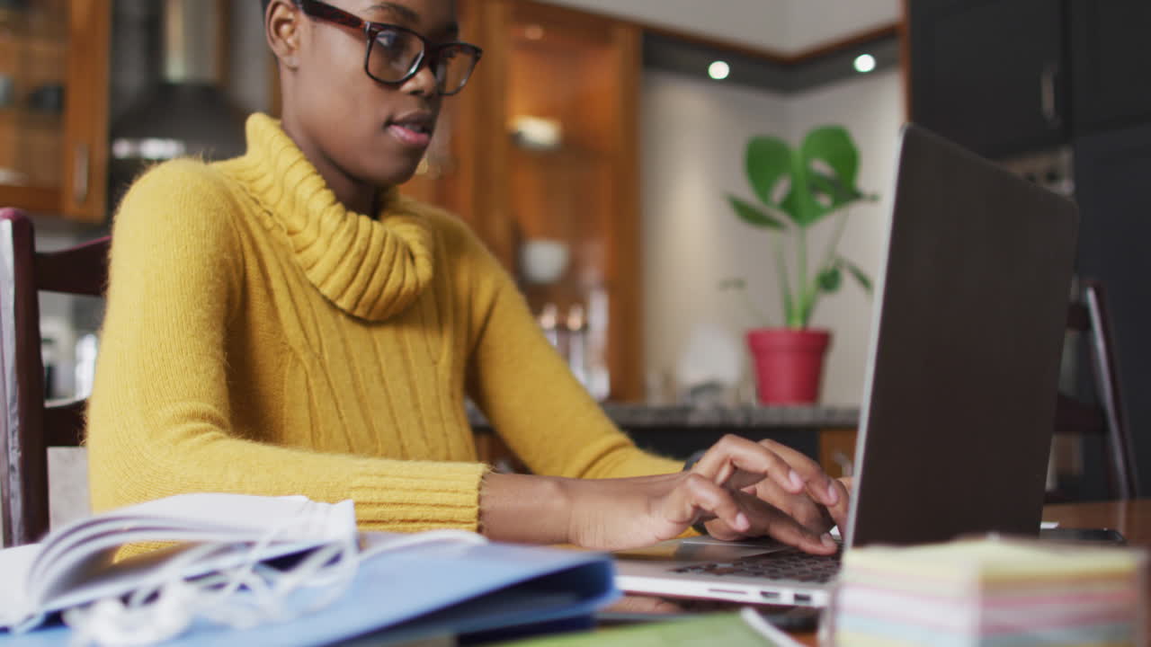 African american woman using laptop while working from home