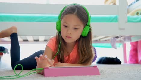 Girl-using-digital-tablet-on-floor-at-home-4k