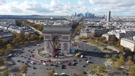 drone view of the arc de triomphe and the streets of paris in the background.