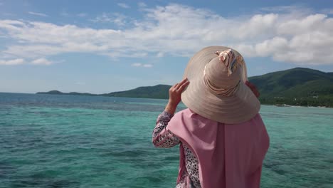 woman tourist in summer hat enjoying summer holiday at karimun jawa