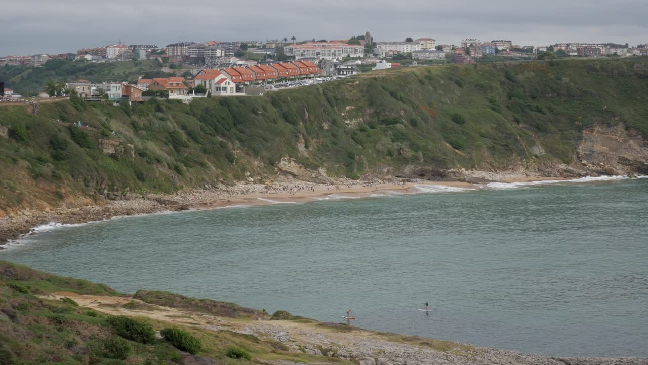 Playa de los Locos beach in Suances, Cantabria, offering scenic coastal views with people enjoying the sunny day