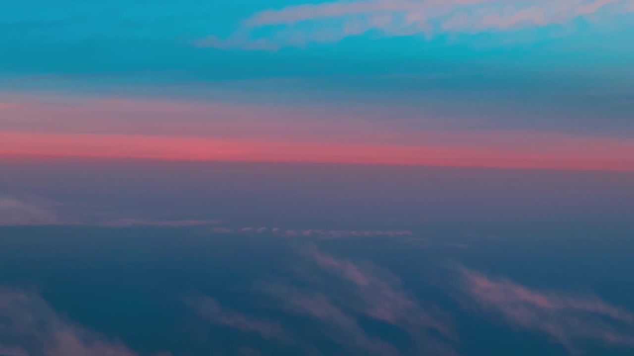 Pastel pink and blue sky gradients above wispy cloud formations at twilight
